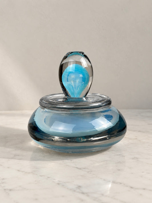 Murano art glass lidded dish with a rounded blue and smoky grey glass body, clear glass cover and sculptural turquoise-blue finial.