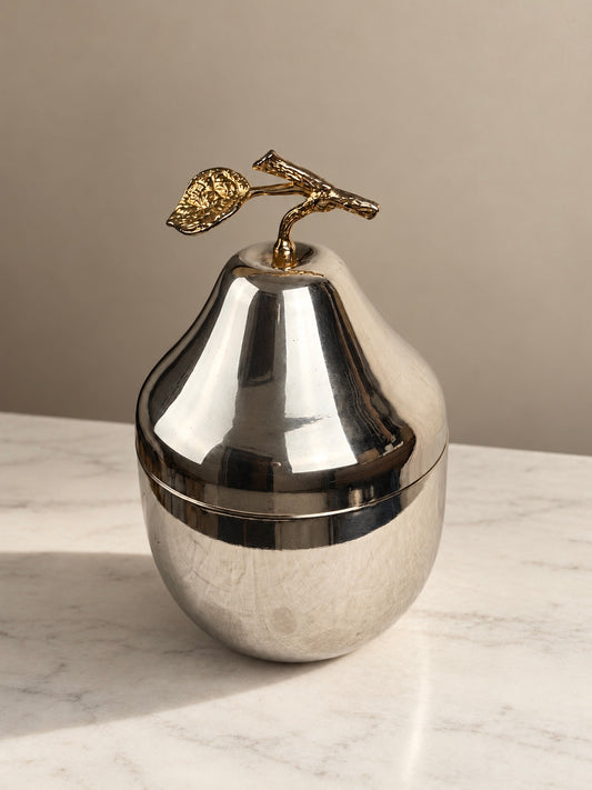 Silver plated pear-shaped ice bucket with a removable lid, gold plated stem and leaf handle, and white insulated interior.