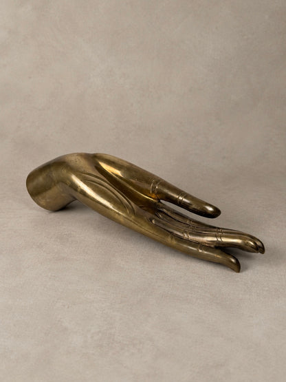 Sculptural brass hand with an elongated open palm, engraved finger detailing and a naturally aged golden brass finish.