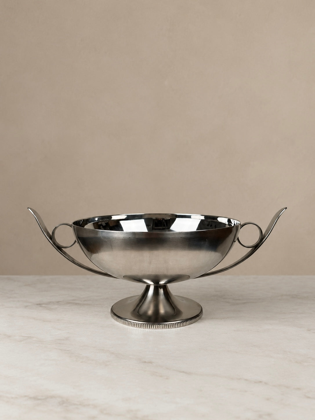 French stainless steel pedestal bowl by Bouillet & Bourdelle with sweeping curved handles, circular detailing and a reeded pedestal base.