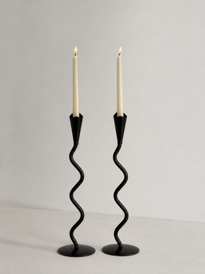Pair of hand forged iron candlesticks with sculptural wavy stems