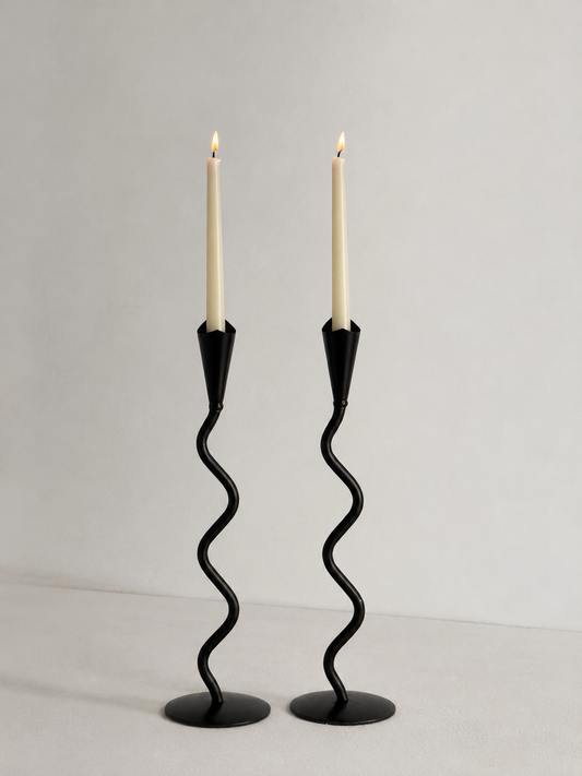 Pair of hand forged iron candlesticks with sculptural wavy stems