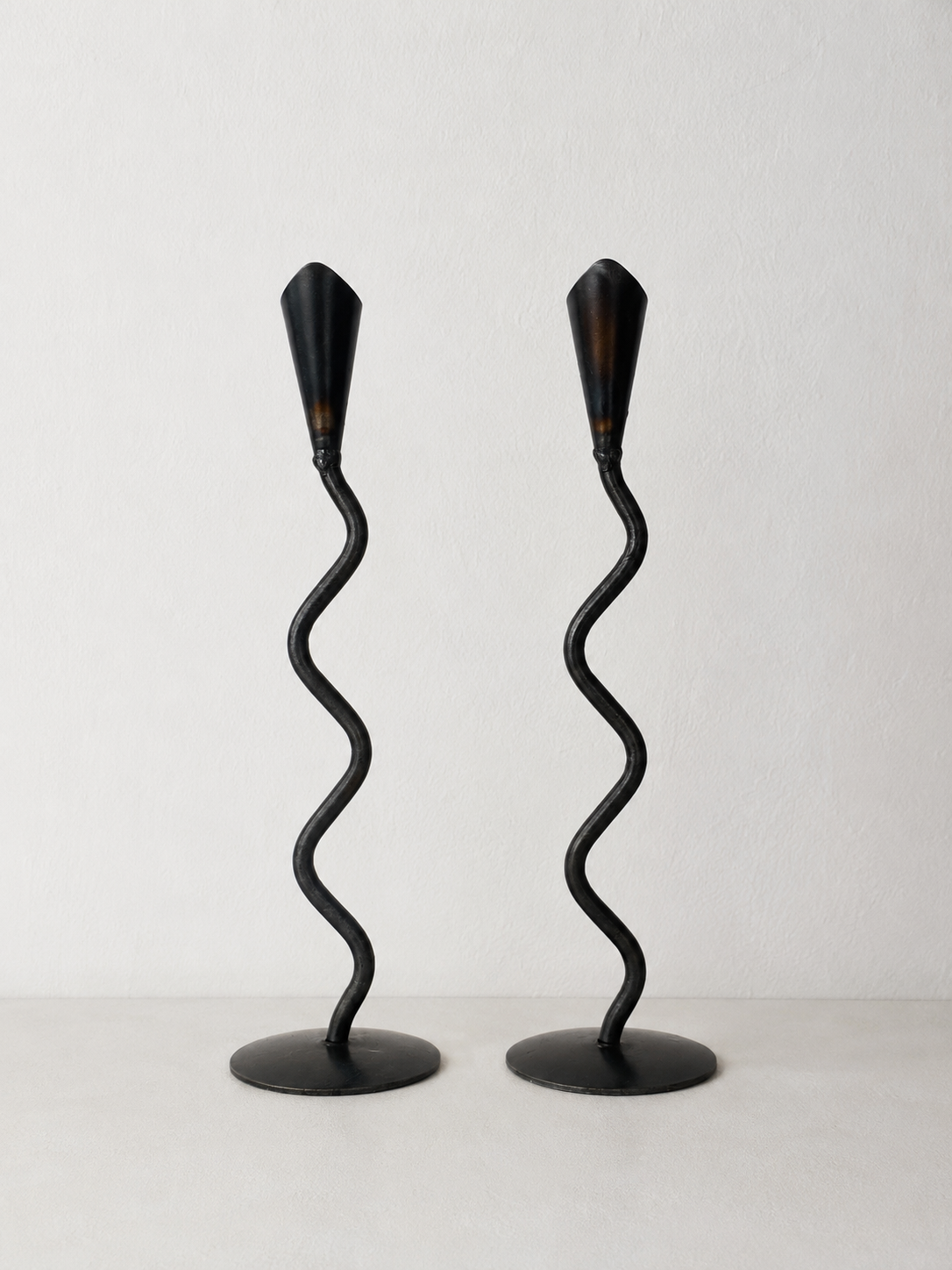 Pair of Hand Forged Iron Wavy Candlesticks