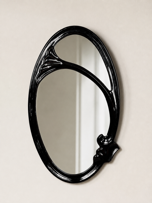 Art Nouveau black enamelled cast iron wall mirror with flowing organic frame