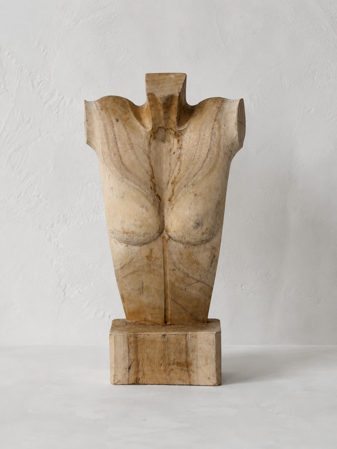 Carved wooden female torso sculpture